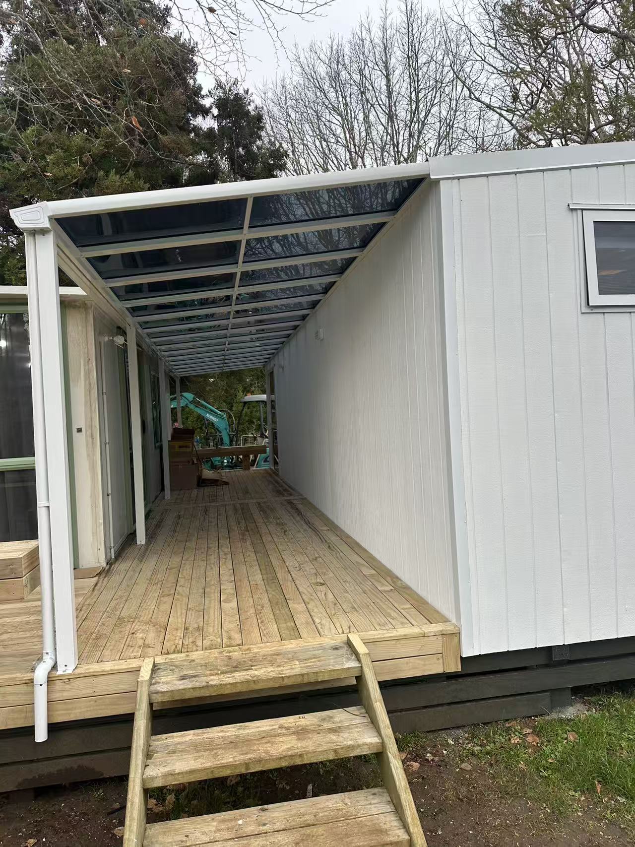 White frame lean-to canopy over a long deck