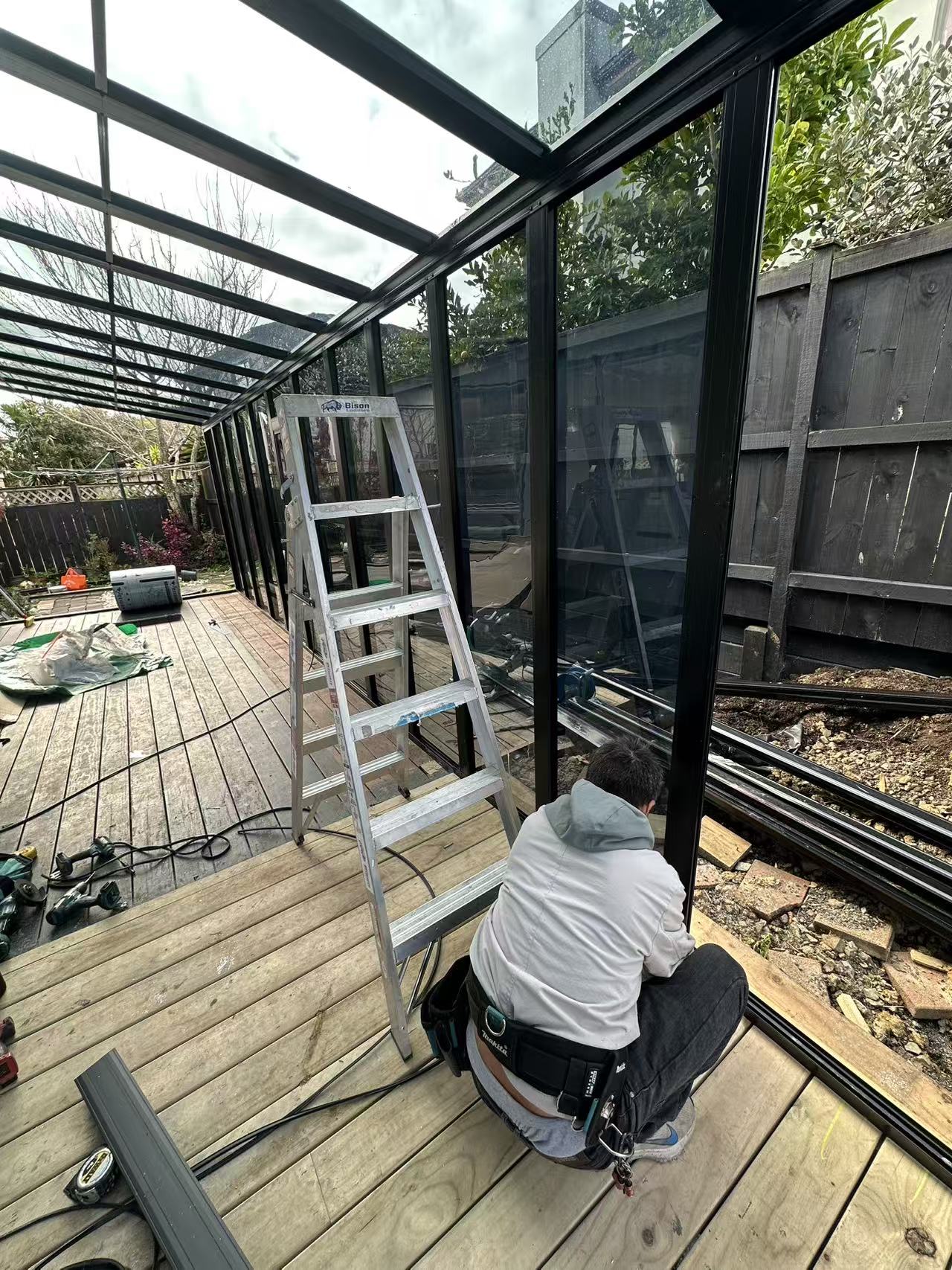 Installer fitting glazing panels on site