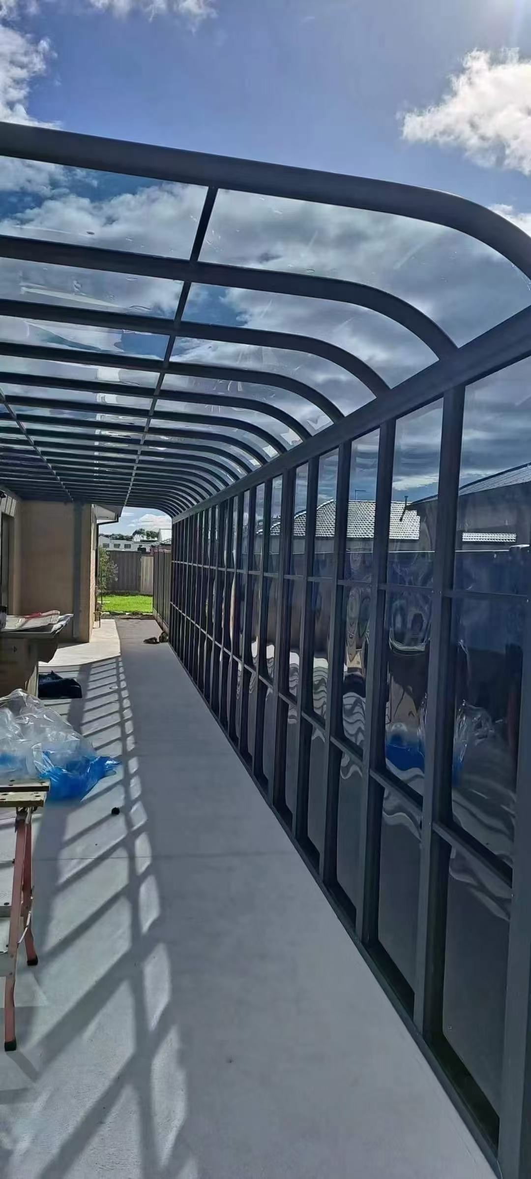 Curved roof glazed walkway enclosure